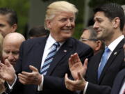 President Donald Trump talks to House Speaker Paul Ryan of Wis. in the Rose Garden of the White House in Washington, on May 4 after the House pushed through a health care bill. Trump promised to make health care more affordable but a government report finds that out-of-pocket costs — deductibles and copayments — would average 61 percent higher under the House Republican bill.