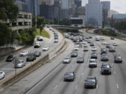 Traffic flows out of downtown Atlanta on the Interstate 75/85 Connector in May 2016. More people are expected to put down the TV remote and hit the road for the July 4 weekend. Auto club AAA predicts that 44.2 million people will travel over the holiday period, most of them by car, up 2.9 percent over a year earlier.