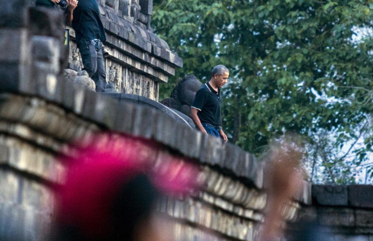 Former U.S. President Barack Obama, center, walks down the stairs of Borobudur Temple during a tour in Magelang, Central Java, Indonesia, on Wednesday. Obama and his family wrapped up their five-day vacation on Indonesia’s resort island of Bali and headed to the historic city of Yogyakarta on Wednesday during a nostalgic trip to the country where Obama lived for several years as a child.