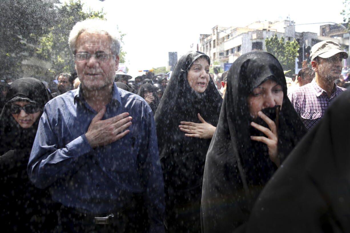 Iranians attend a funeral ceremony for victims of Wednesday’s militant attack Friday in Tehran.