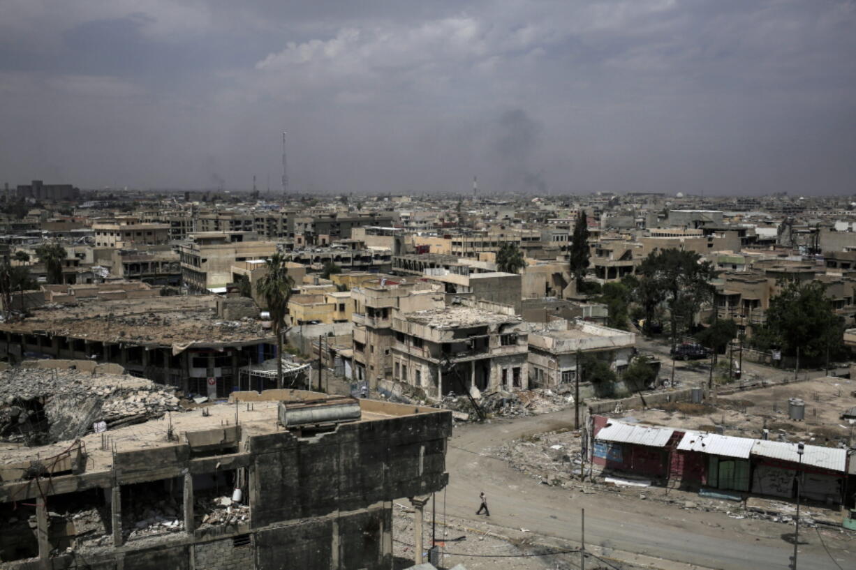 FILE -- In this May 5, 2017 file photo, destroyed buildings from fighting between Iraqi forces and the Islamic State group are seen in western Mosul.