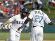 Texas Rangers' Mike Napoli, left, is congratulated by third base coach Tony Beasley (27) after hitting a two-run home run in the sixth inning of a baseball game against the Seattle Mariners, Saturday, June 17, 2017, in Arlington, Texas.