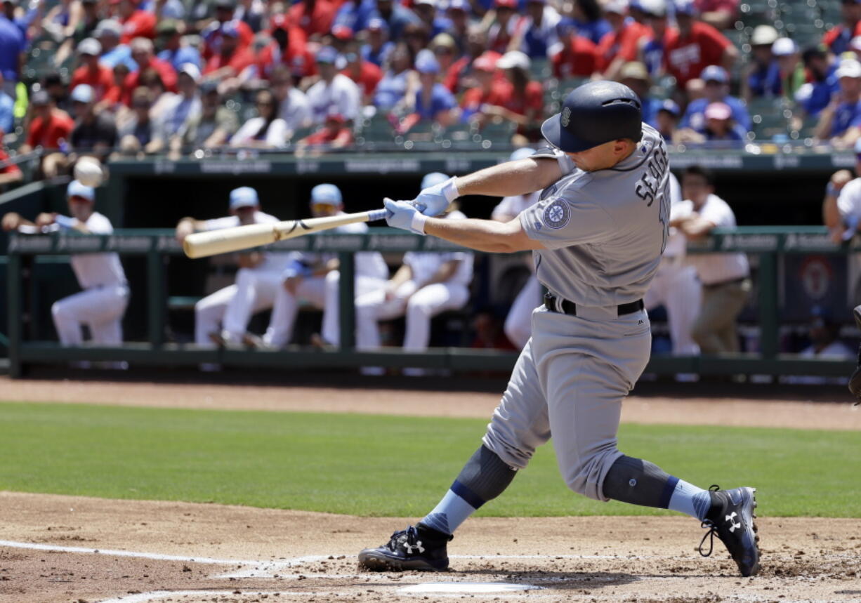 Seattle Mariners' Kyle Seager follows through on a run-scoring double off a pitch from Texas Rangers' Yu Darvish during the first inning of a baseball game, Sunday, June 18, 2017, in Arlington, Texas.