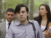 Former Turing Pharmaceuticals CEO Martin Shkreli arrives at Brooklyn federal court with members of his legal team, in New York, for a pretrial conference in his securities fraud trial. Shkreli’s trial begins Monday.