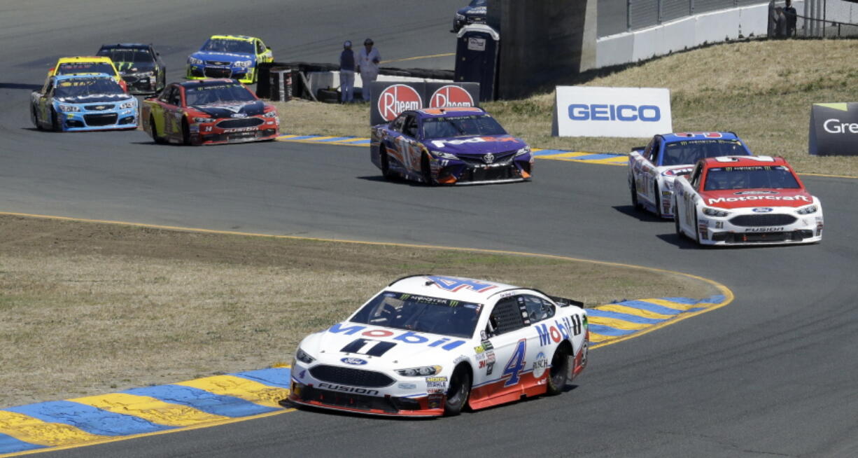 Kevin Harvick (4) leads through a turn during the NASCAR Sprint Cup Series auto race Sunday, June 25, 2017, in Sonoma, Calif.