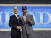 Washington’s Markelle Fultz, right, poses for a photo with NBA Commissioner Adam Silver after being selected by the Philadelphia 76ers as the No. 1 pick overall during the NBA basketball draft, Thursday, June 22, 2017, in New York.