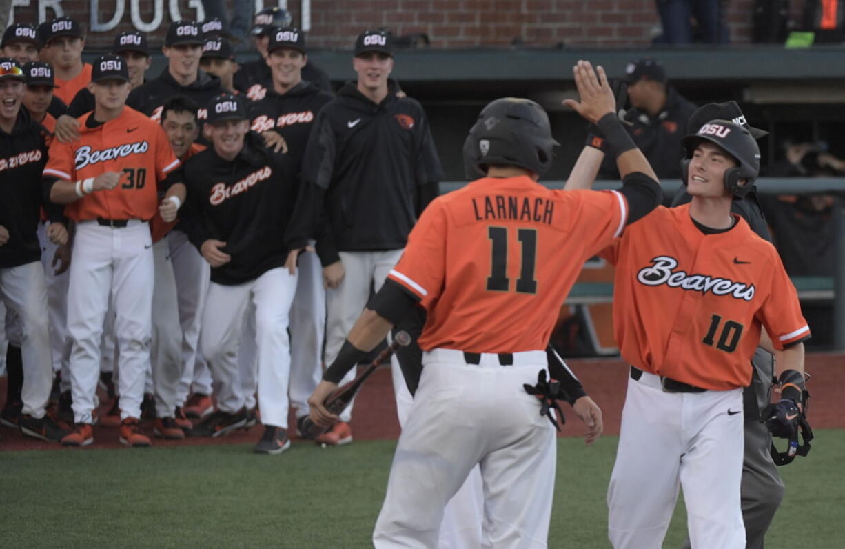 Oregon State's Michael Gretler (10) celebrates his home run against Yale with Trevor Larnach (11) and Adley Rutschman, behind Larnach, during an NCAA college baseball regional tournament game in Corvallis, Ore., Sunday, June 4, 2017.