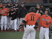 Oregon State's Michael Gretler (10) celebrates his home run against Yale with Trevor Larnach (11) and Adley Rutschman, behind Larnach, during an NCAA college baseball regional tournament game in Corvallis, Ore., Sunday, June 4, 2017.