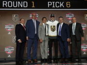 Cody Glass, third from right, wears a Vegas Golden Knights jersey after being selected by the team in the first round of the NHL hockey draft, Friday, June 23, 2017, in Chicago. (AP Photo/Nam Y.