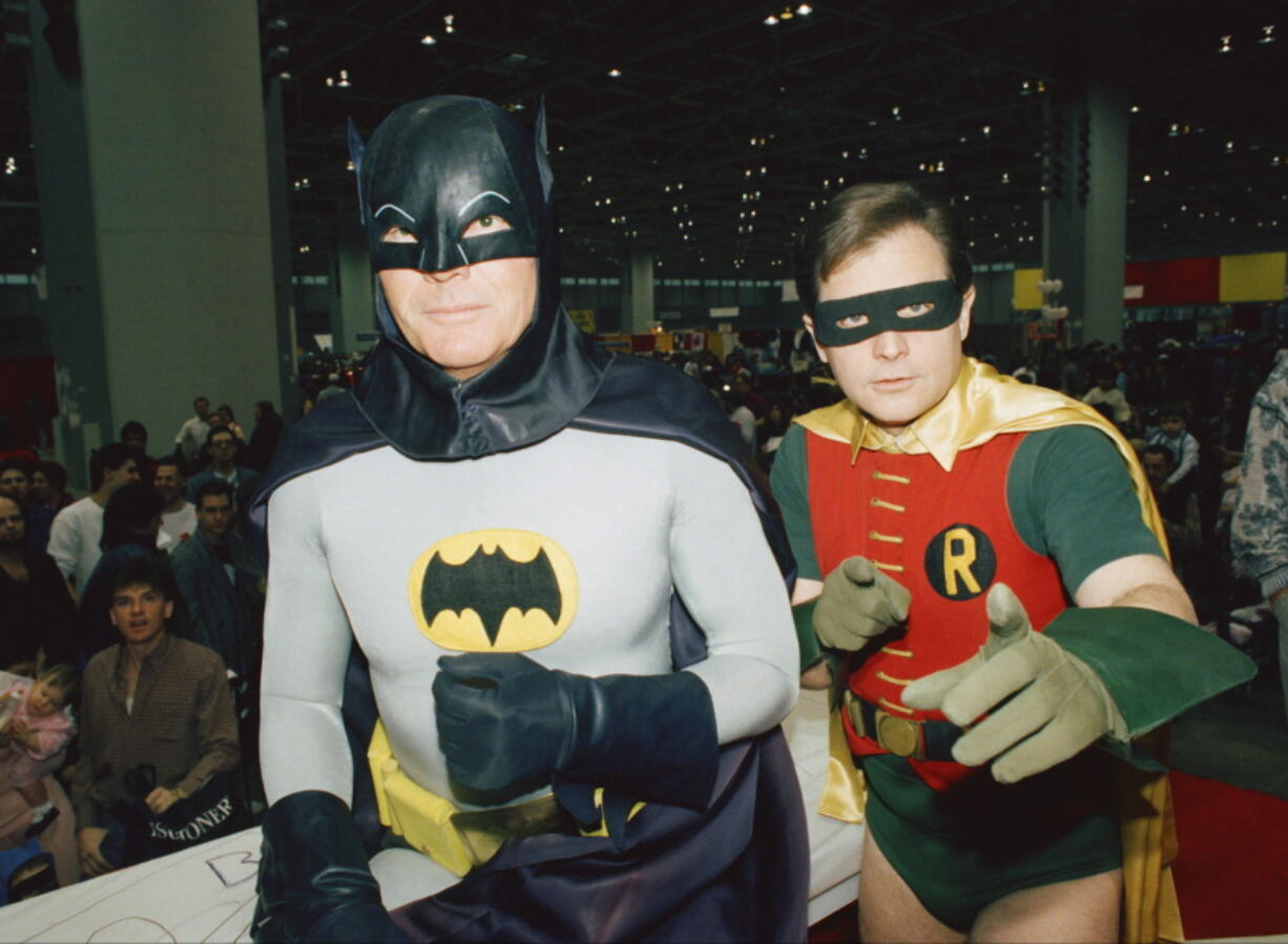 Actors Adam West, left, and Burt Ward, dressed as their characters Batman and Robin, pose for a photo at the "World of Wheels" custom car show in Chicago on Sunday, Jan. 27, 1989. On Saturday, June 10, 2017, West's family said the actor, who portrayed Batman in a 1960s TV series, has died at age 88.