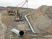 Heavy equipment is seen at a site where sections of the Dakota Access pipeline were being buried near the town of St. Anthony in Morton County, N.D., in October. The 1,200-mile line carrying North Dakota oil through South Dakota and Iowa to a distribution point in Illinois began commercial service Thursday, June 1, 2017.