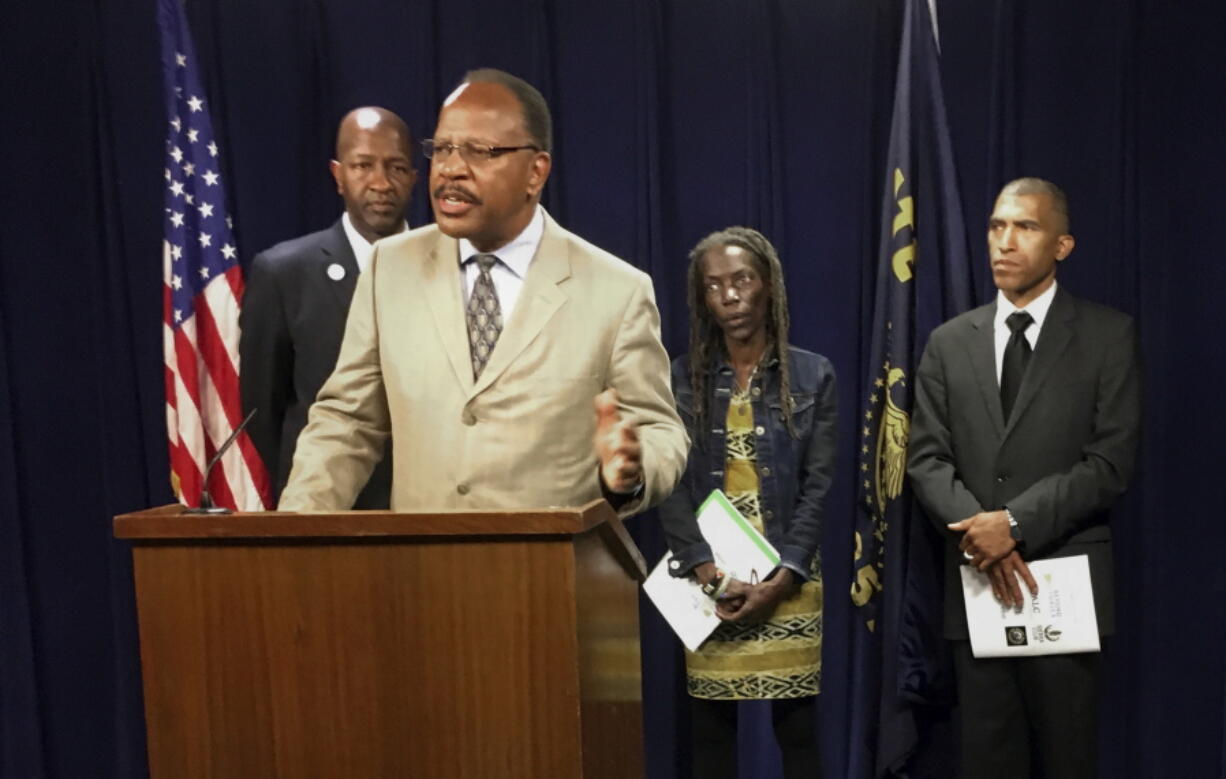 The presidents of the four branches in Oregon of the NAACP, from left, Frederick Edwards, Corvallis branch; Benny Williams, at podium Salem-Keiser branch; Jo Anne Hardesty, Portland branch; and Eric Richardson, Eugene-Springfield branch, attend a news conference Monday at the state Capitol in Salem, Ore. The four came to Capitol to support several bills, including one designed to end racial profiling by police.