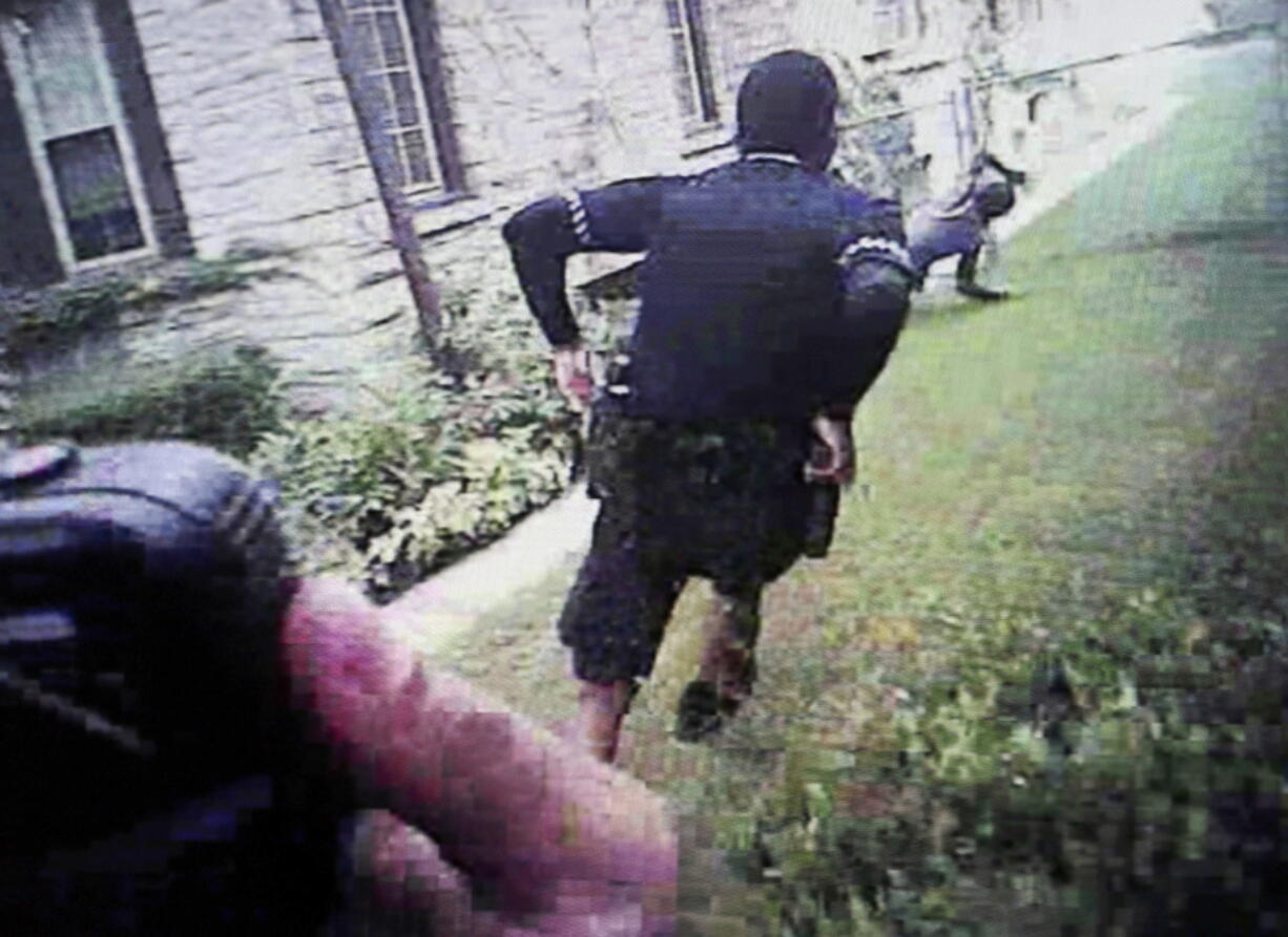 This image from video, taken during the trial of Milwaukee police officer Dominique Heaggan-Brown in Milwaukee, shows Milwaukee Police Department body camera video of Heaggan-Brown, center, running behind 23-year-old Sylville Smith, right, after a routine traffic stop on Aug. 23, 2016. The dramatic footage prompted the Smith’s relatives to leave the courtroom in tears after seeing the brief foot chase that quickly turned fatal.