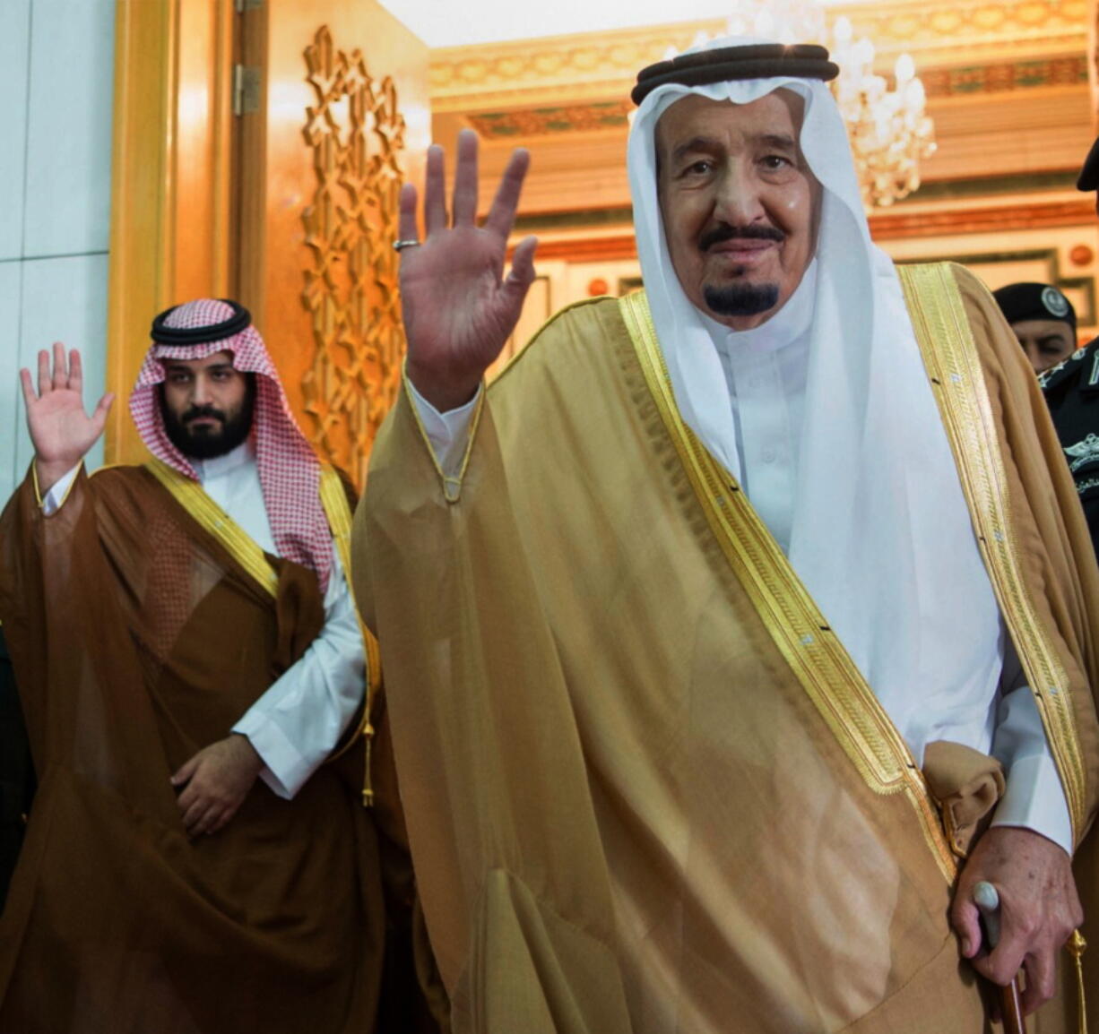 Saudi King Salman, right, and Defense Minister and Deputy Crown Prince Mohammed bin Salman wave as they leave the hall after talks with the British prime minister, in Riyadh, Saudi Arabia. Saudi King Salman has put his 31-year-old son, Mohammed bin Salman, next in line to take over the oil-rich kingdom with a royal decree Wednesday.