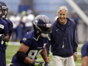 Seattle Seahawks head coach Pete Carroll, right, smiles as he watches Doug Baldwin run a drill during NFL football practice Thursday, June 15, 2017, in Renton, Wash.