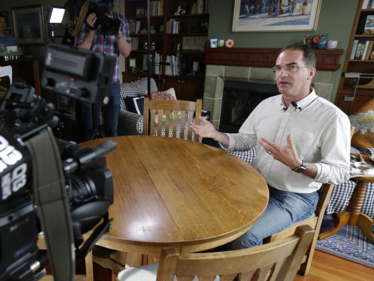 Mark Elster talks to reporters Wednesday during a news conference in his Seattle home. Elster is a plaintiff in a suit challenging Seattle’s voucher system for campaigns. Ted S.