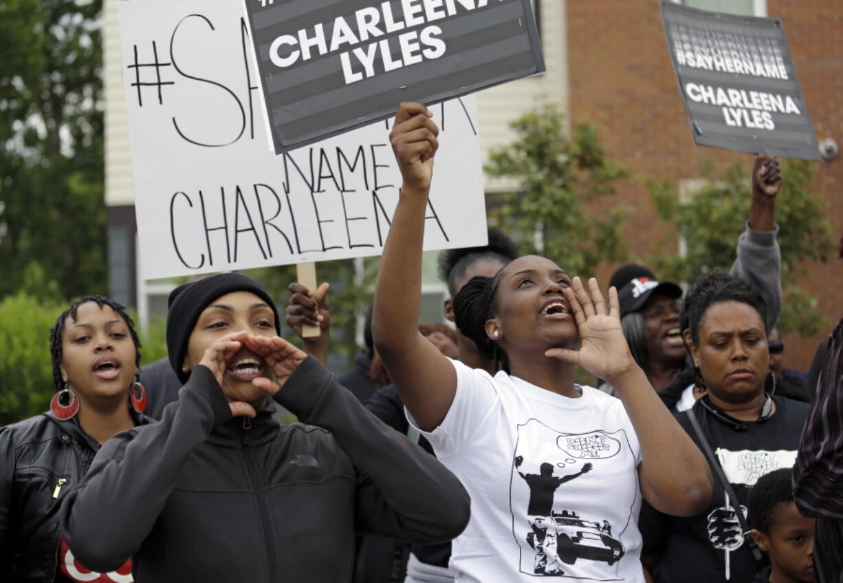 Relatives and friends of a pregnant mother who was shot and killed by police chant Tuesday at a gathering near the place she was killed in Seattle. Charleena Lyles was killed Sunday after she confronted the officers with knives.