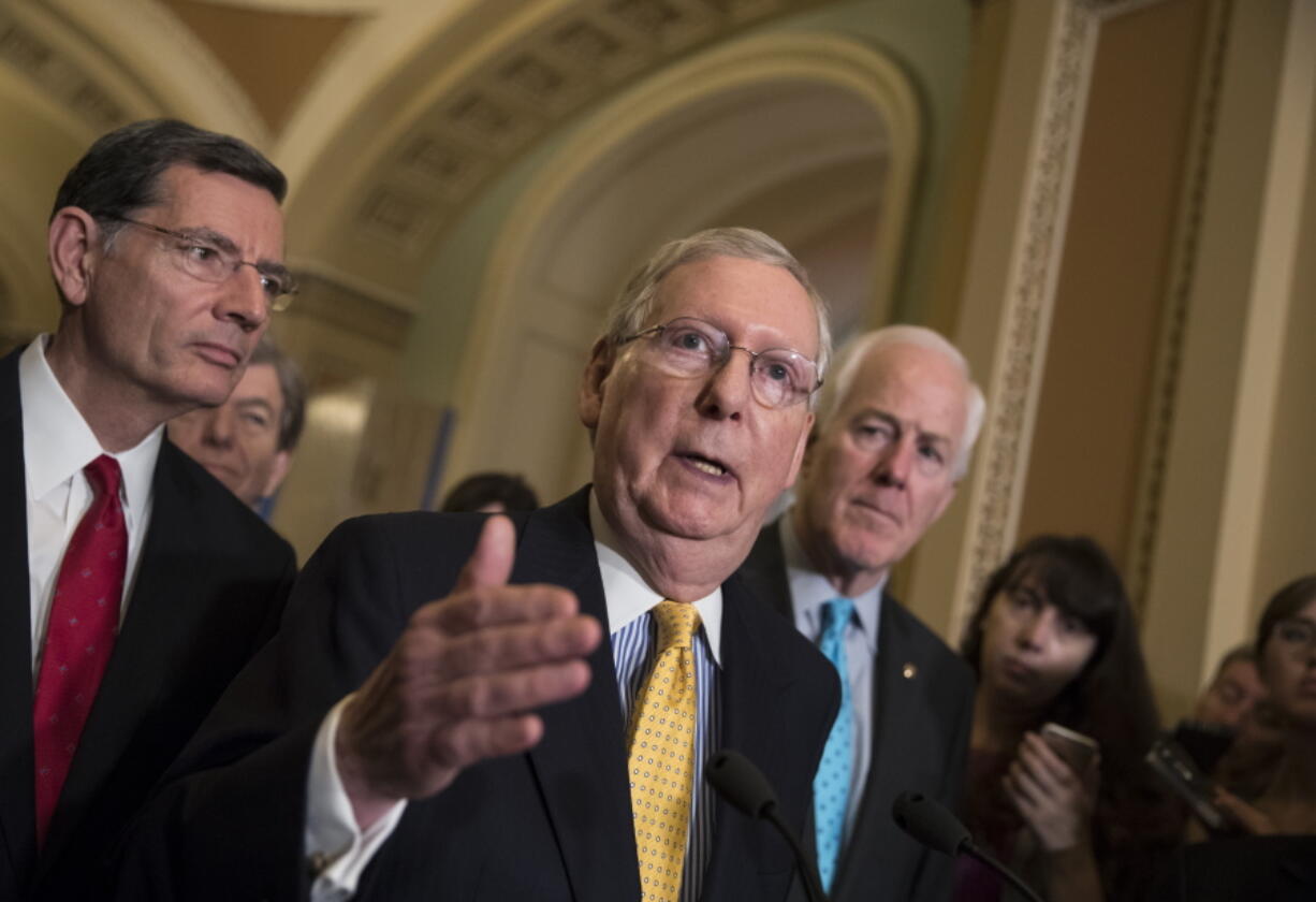 Senate Majority Leader Mitch McConnell, R-Ky., flanked by Sen. John Barrasso, R-Wyo., left, and Majority Whip John Cornyn, R-Texas, meets with reporters at the Capitol in Washington, Tuesday, June 6, 2017. (AP Photo/J.