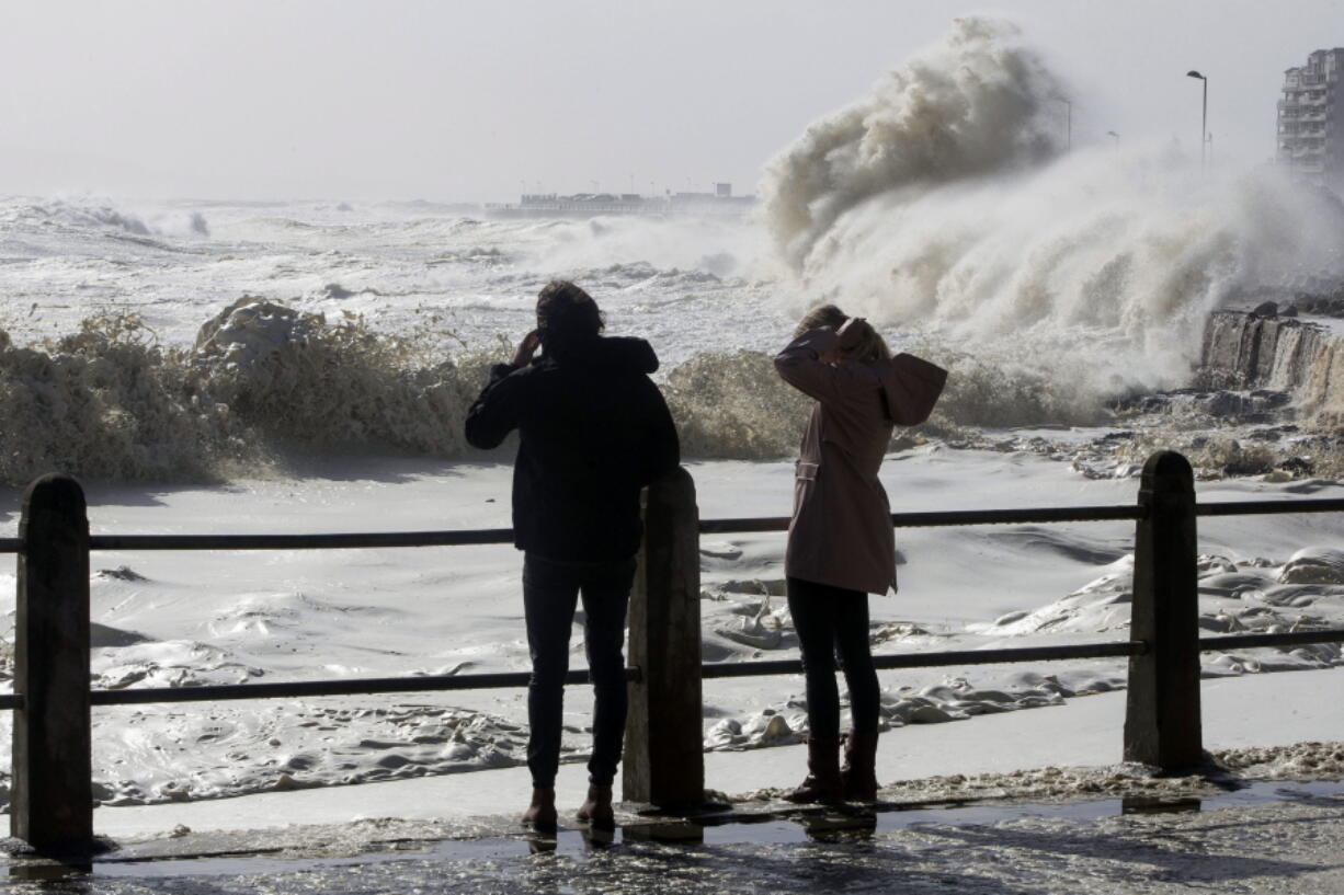 Huge waves slam into the promenade during heavy storms in the Sea Point neighborhood of Cape Town, South Africa, on Wednesday, June 7, 2017. South African media are reporting that several people have been killed in a storm that swept into the area around Cape Town. The region has been suffering a severe drought. News24 says four people were killed in a fire caused by lightning and another person died when a house collapsed.