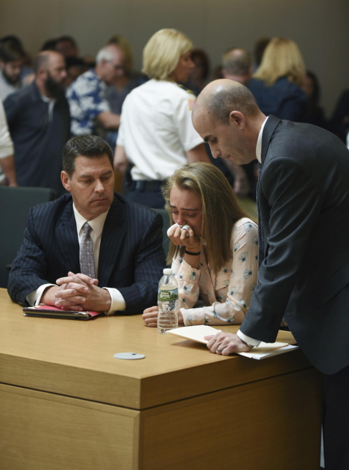 Michelle Carter cries while flanked by defense attorneys Joseph Cataldo, left, and Cory Madera, after being found guilty of involuntary manslaughter in the suicide of Conrad Roy III on Friday in Bristol Juvenile Court in Taunton, Mass.