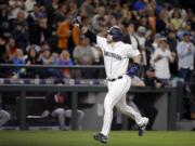 Seattle Mariners' Mike Zunino points toward the stands as he heads home on his two-run home run against the Detroit Tigers in the sixth inning of a baseball game Monday, June 19, 2017, in Seattle.