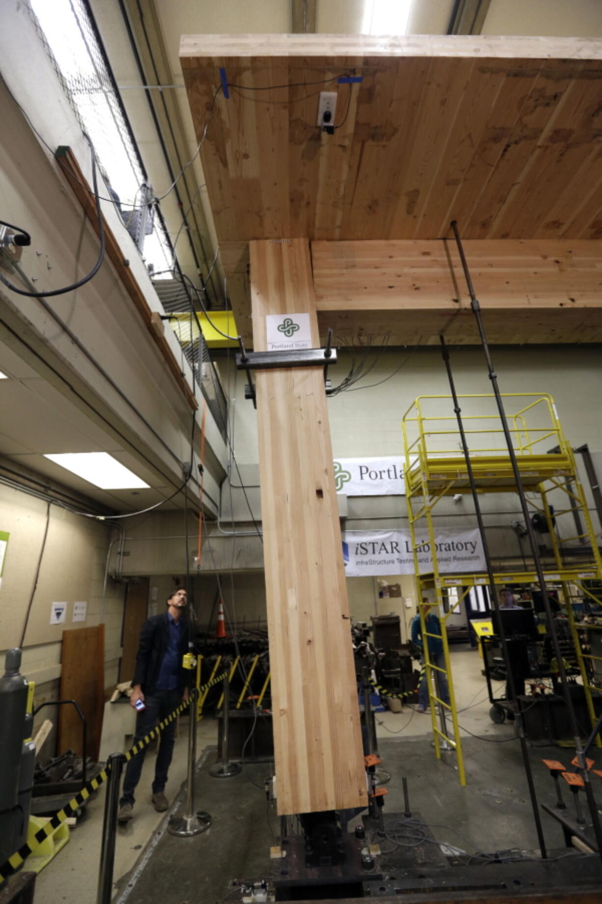 Lever Architecture founder Thomas Robinson looks over a strength test on cross-laminated timber beams, or CLT, at Portland State University in Portland.