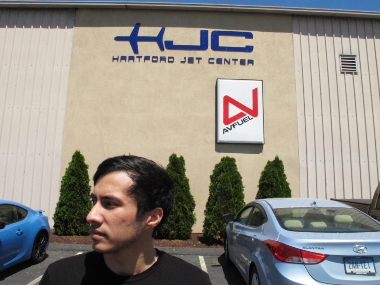 Arslan Mamiliyev, who was training to become a commercial pilot at the American Flight Academy in Hartford, Conn., stands outside the building where the school was located. He and other international students are suing the school, saying they lost thousands of dollars and are being forced to leave the country after the school closed following two fatal plane crashes. Federal authorities are investigating the crashes and have seized records from the school.