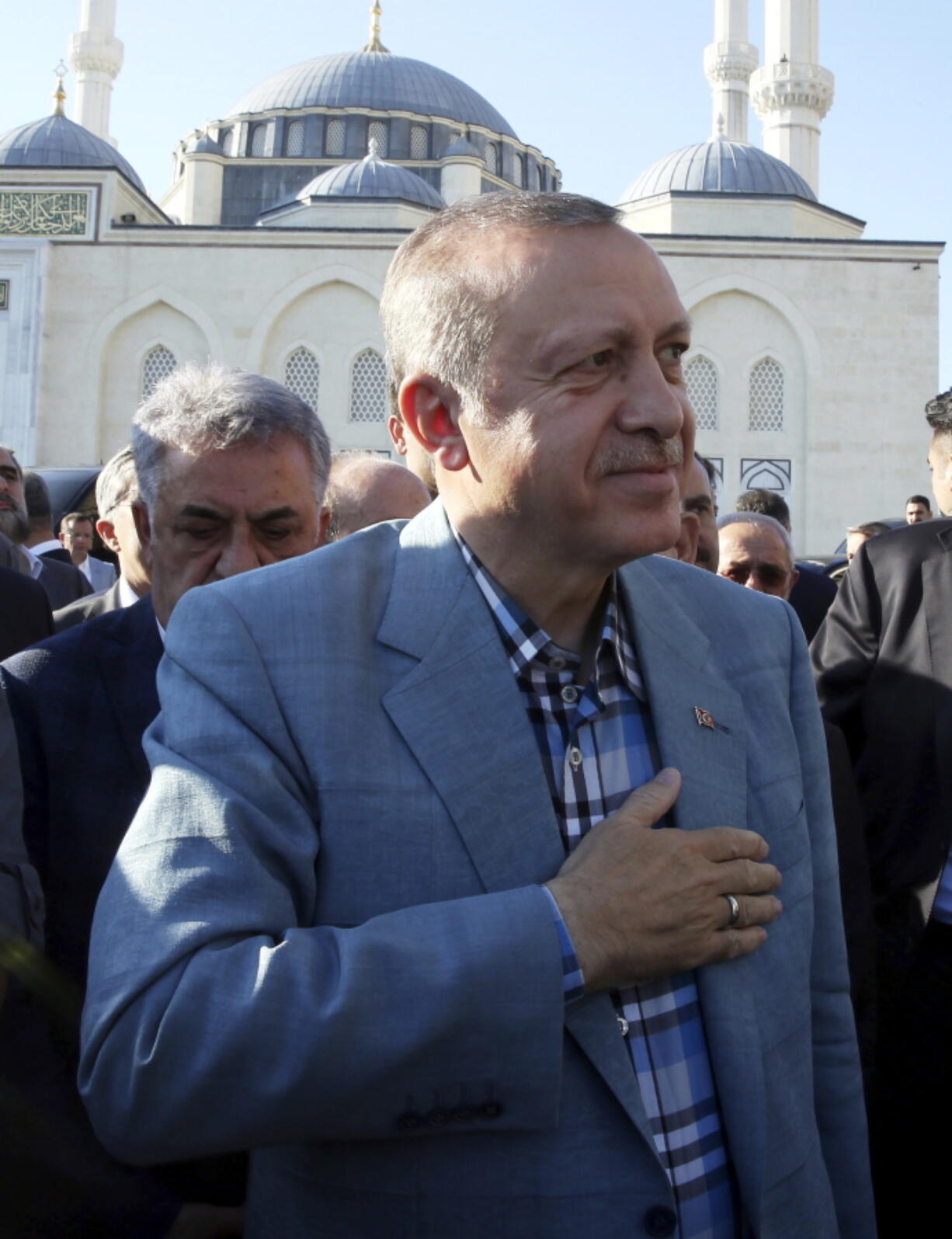 Turkey's President Recep Tayyip Erdogan smiles to his supporters after the Eid al-Fitr prayers in Istanbul, early Sunday, June 25, 2017.