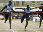 Justin Gatlin, left, reacts as he defeats Christian Coleman, center, in the men’s 100-meter final at the U.S. Track and Field Championships at Sacramento on Friday.