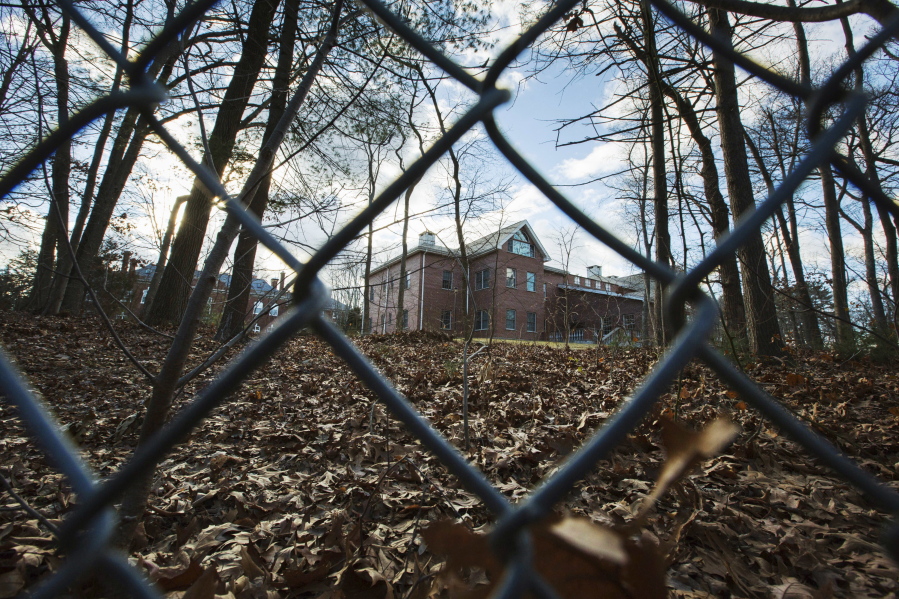 FILE - In this Dec. 30, 2016 file photo, a fence encloses an estate in the village of Upper Brookville in the town of Oyster Bay, N.Y., on Long Island, after the Obama administration closed this compound for Russian diplomats. The U.S. and Russia are holding high-level negotiations that could lead to the return of two Russian diplomatic compounds seized as punishment for MoscowÇƒÙs alleged interference in the U.S. presidential election. (AP Photo/Alexander F.