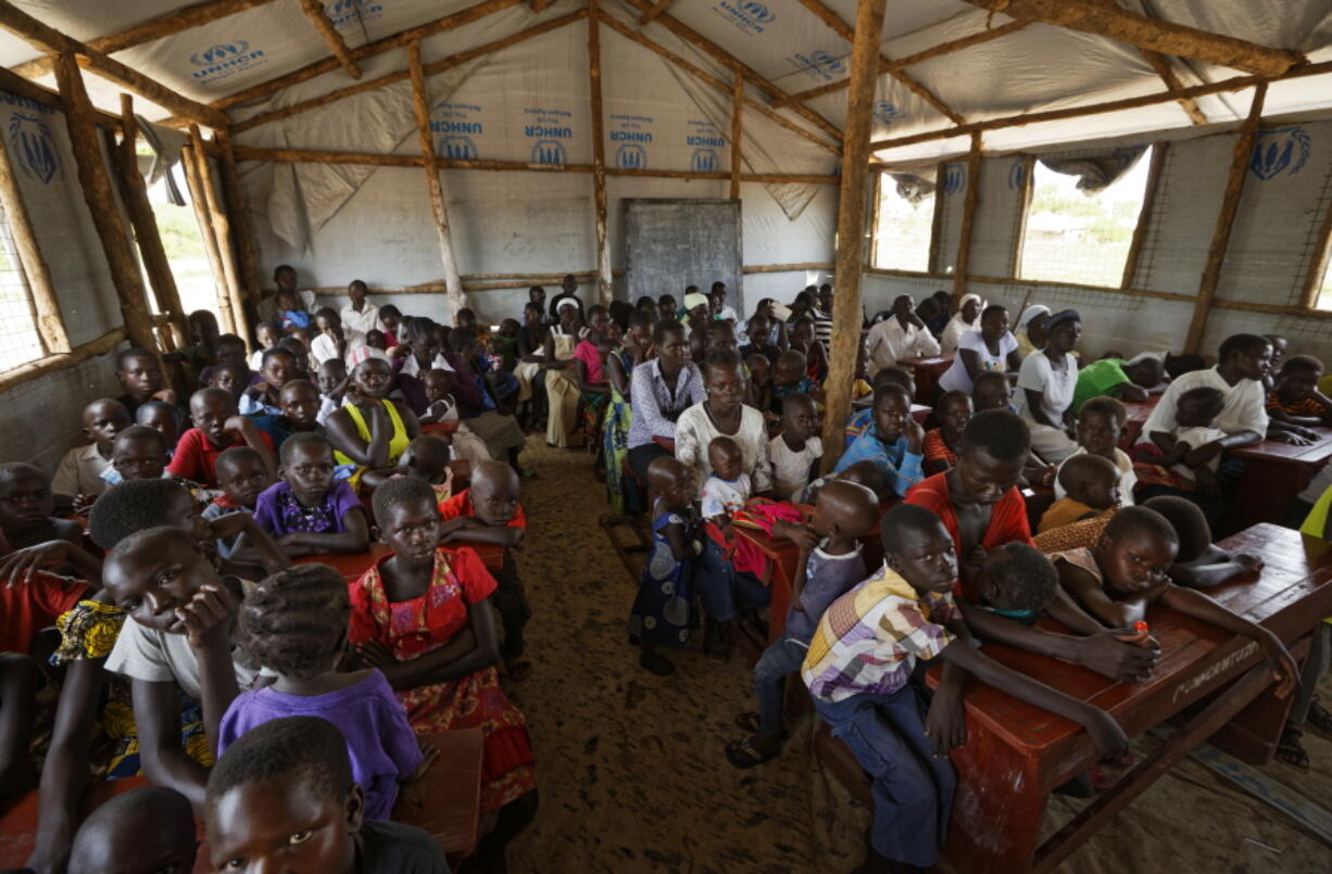 The congregation attends a Sunday service at the United Church, which is held in a school classroom tent, in Bidi Bidi refugee settlement in northern Uganda.