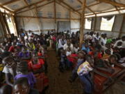 The congregation attends a Sunday service at the United Church, which is held in a school classroom tent, in Bidi Bidi refugee settlement in northern Uganda.