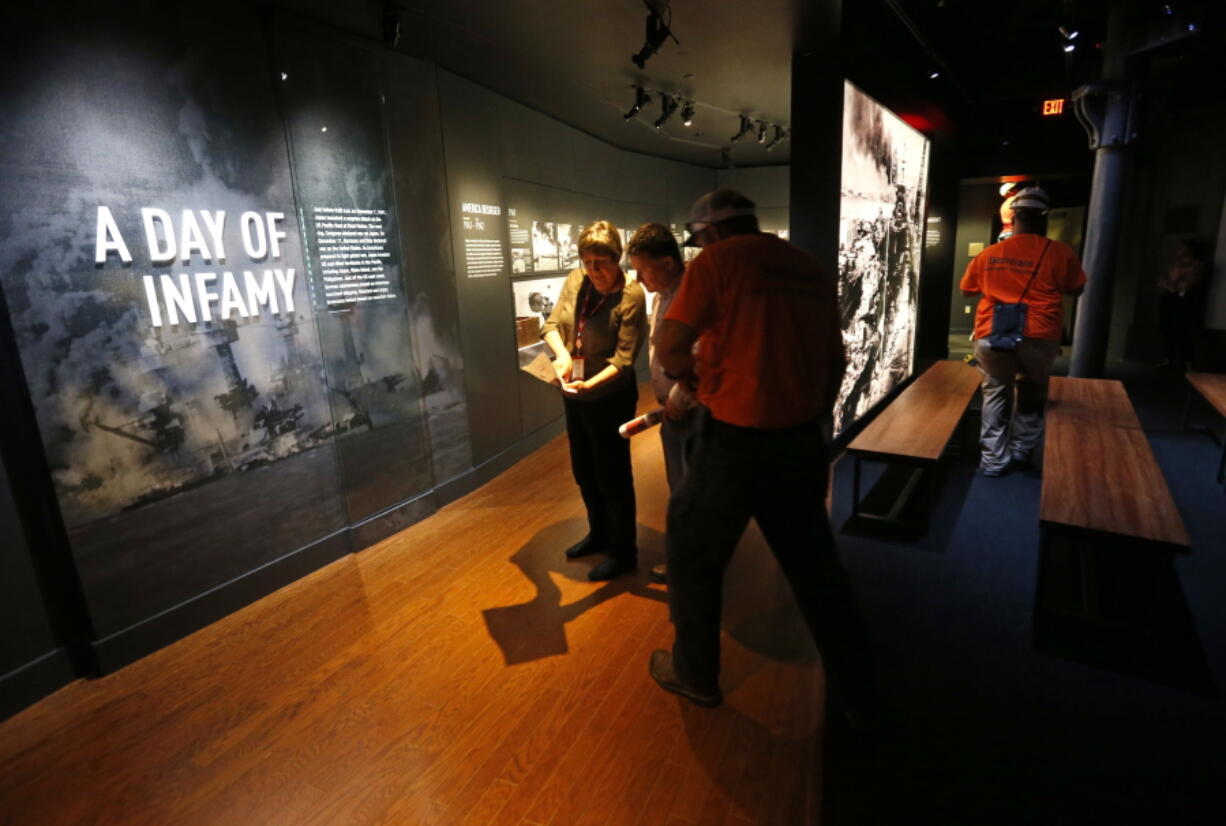 Workers go over the final installation of the permanent exhibit “Salute to the Home Front” Monday at the National World War II Museum, which opened to the public Saturday. The exhibit tells the home front story from the 1920s to the development of the atomic bomb.