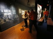 Workers go over the final installation of the permanent exhibit “Salute to the Home Front” Monday at the National World War II Museum, which opened to the public Saturday. The exhibit tells the home front story from the 1920s to the development of the atomic bomb.