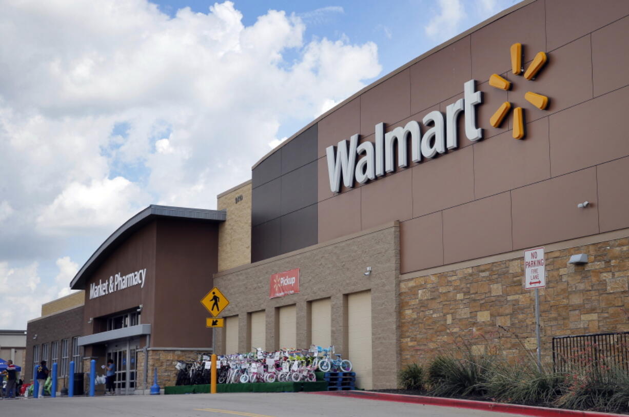 People walk in and out of a Wal-Mart store in Dallas.