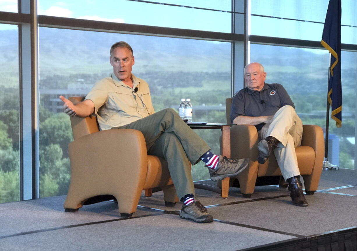 U.S. Interior Secretary Ryan Zinke, left, and Agriculture Secretary Sonny Perdue speak in Boise, Idaho, on Friday.