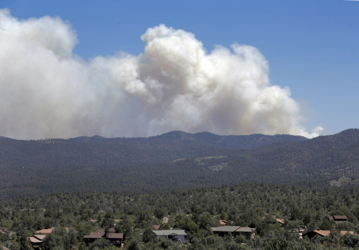 A wildfire burns near Mayer, Ariz, Wednesday, June 28, 2017, as seen from Prescott Valley, Ariz. The fire about 100 miles north of Phoenix has forced the evacuation of Mayer and parts of Dewey-Humboldt along with several other communities. Some areas and subdivisions are under pre-evacuation notices.