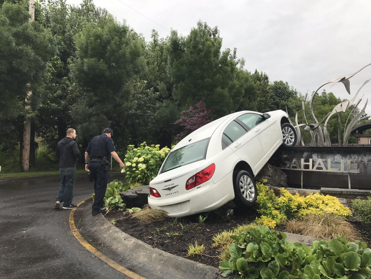 Vancouver police are investigating after a crashed vehicle was found Thursday morning atop the sign for The Sahalie at Tidewater, condos along the waterfront.