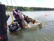 The Multnomah County Sheriff’s Office Dive Team and crews from Fred Devine Salvage, a marine salvage contractor, worked to locate and recover a sunken boat out of the the Columbia River Wednesday. Investigators will assess the vessel to help determine what caused it to crash into a pylon, ultimately killing an Oregon woman.