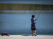 Logan Lewi, 10, of Vancouver fishes at Klineline Pond in Salmon Creek.