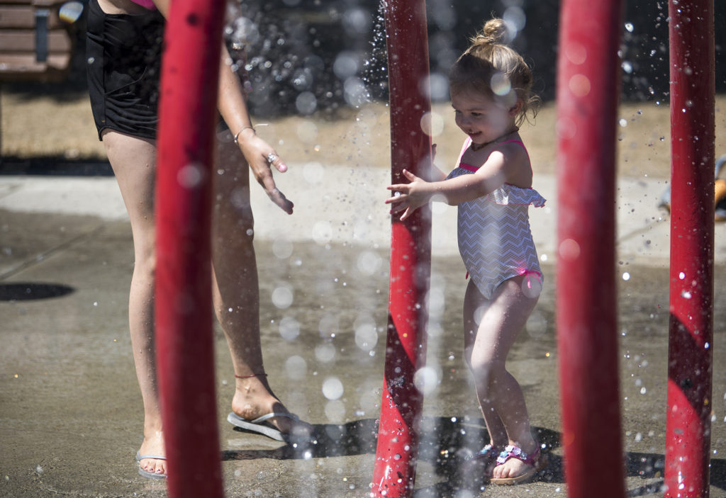 Maddie Adams, 3, plays with her mother, Jackie, both of Vancouver, on Monday afternoon July 31, 2017, at Klineline Pond in Salmon Creek.