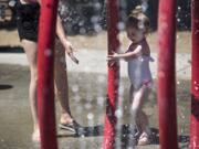 Maddie Adams, 3, plays with her mother, Jackie, both of Vancouver, on Monday afternoon July 31, 2017, at Klineline Pond in Salmon Creek.