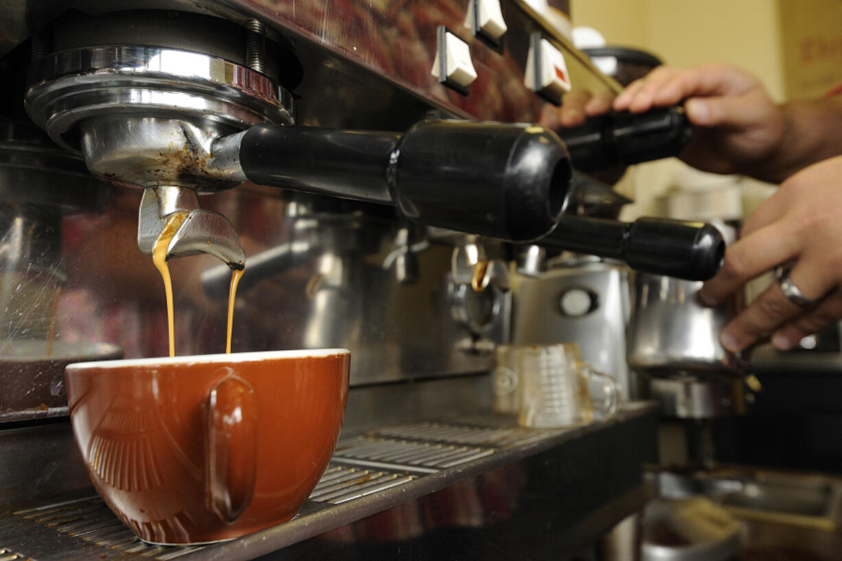 A barista makes a latte at River Maiden Coffee’s previous location. The popular Vancouver coffee shop will open a drive-thru location on MacArthur Boulevard while it continues its search for a permanent home.