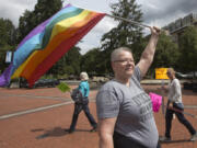 Eva Hoffman holds a rainbow flag at a Pride event at Esther Short Park in downtown Vancouver in 2016. The annual Vancouver USA Pride event celebrates the local LGBTQ community.