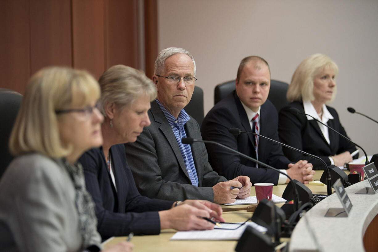 Clark County council members Jeanne Stewart, from left, Julie Olson, Marc Boldt, John Blom and Eileen Quiring discuss the contract of former Clark County Manager Mark McCauley on May 12.