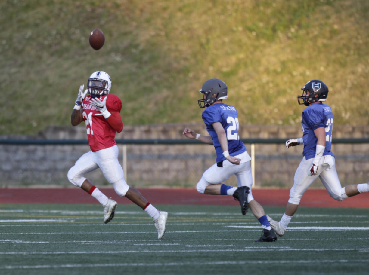 Jeremiah Wright (left) of Skyview hauls in a touchdown pass as Denis Baraiac (center) of Heritage and Devan Riggs (right) of Hockinson.