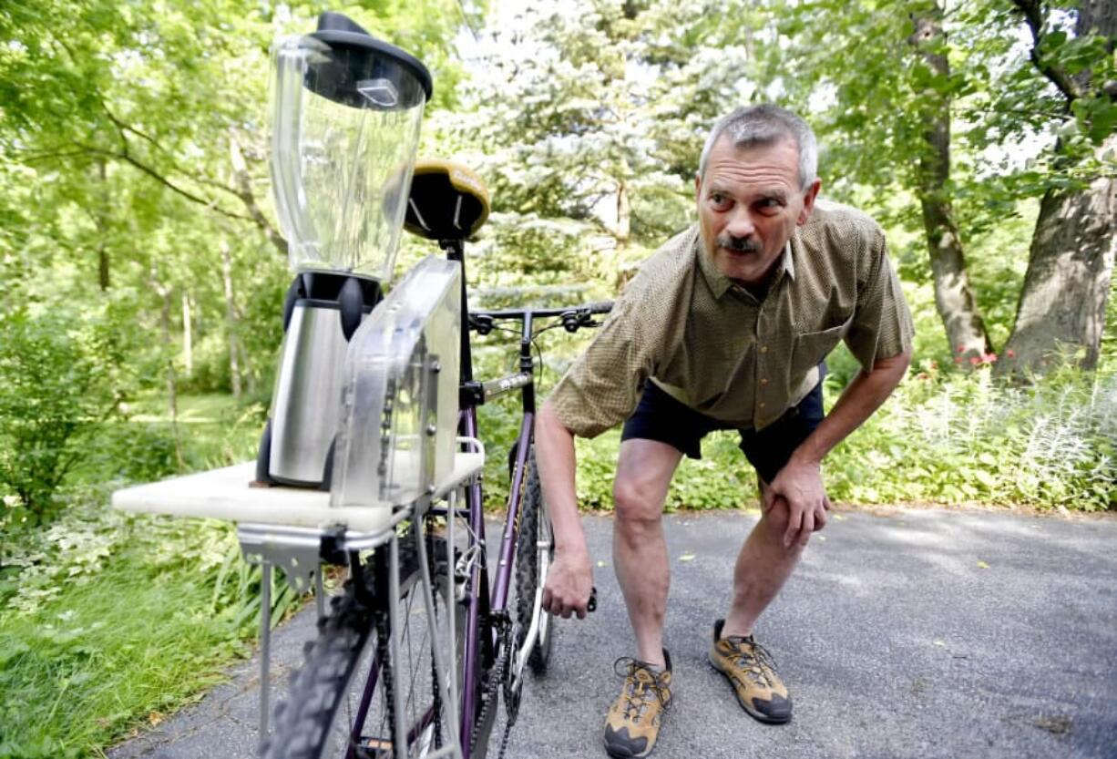 Paul Simpson shows how his homemade blender bike works. The bike helps to make strawberry milkshakes at the Lemont Strawberry Festival each summer.