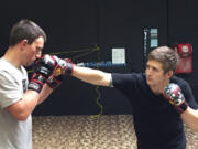 Vancouver mixed-martial-arts fighter Gunnar Metzger, right, trains with a sparring partner at Vancouver Elite Martial Arts. Metzger will fight Saturday at Rumble at the Roseland 93 in Portland.