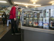 Customers peruse products in a case at Main Street Marijuana in downtown Vancouver. The city’s portion of the marijuana taxes will go toward law enforcement.