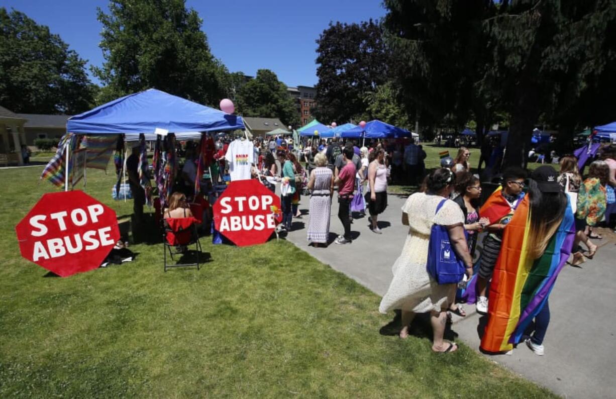 People mill through Vancouver USA Pride on Saturday, exploring booths and carrying rainbow flags. The event, a celebration of the local LGBT community, is hosted by Saturday in the Park Pride every year.